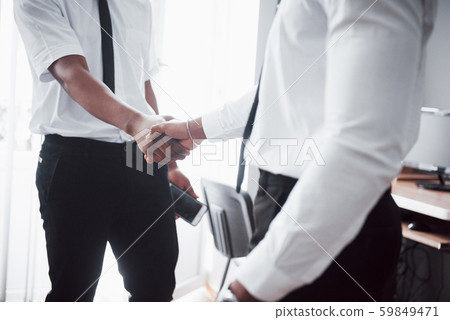 Business partnership concept. Photo of two businessman handshaking process. Successful deal after Business partnership concept. Photo of two businessman handshaking process. Successful deal after 59849471