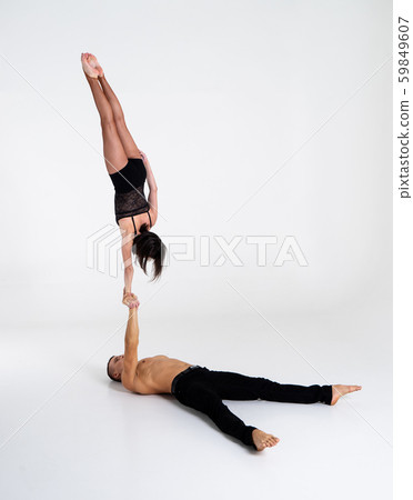Duo Of Acrobats Showing hand to hand Trick, Isolated On White 59849607
