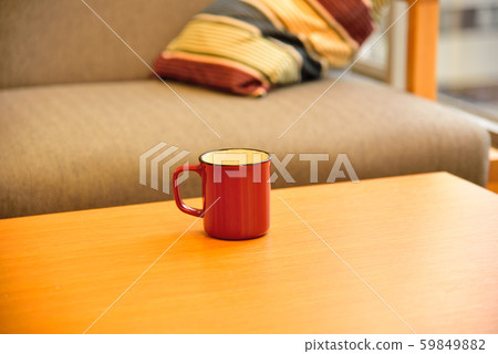 [Business scene] Red mug and sofa placed on a wooden table [Break image] 59849882