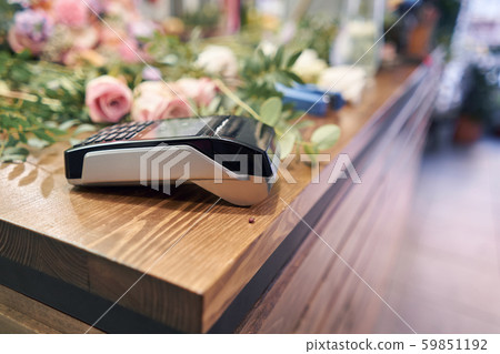 Concept contactless payment. Making payment with smartphone and pos terminal, printed check. Floral Concept contactless payment. Making payment with smartphone and pos terminal, printed check. Floral 59851192