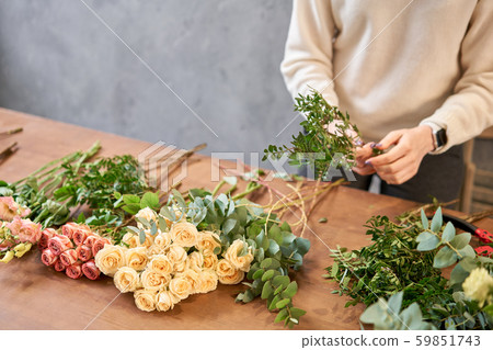 Step by step florist woman creates red beautiful bouquet of mixed flowers. Handsome fresh bunch Step by step florist woman creates red beautiful bouquet of mixed flowers. Handsome fresh bunch 59851743
