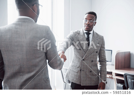 Two handsome cheerful african american executive business man at the workspace office Two handsome cheerful african american executive business man at the workspace office 59851816