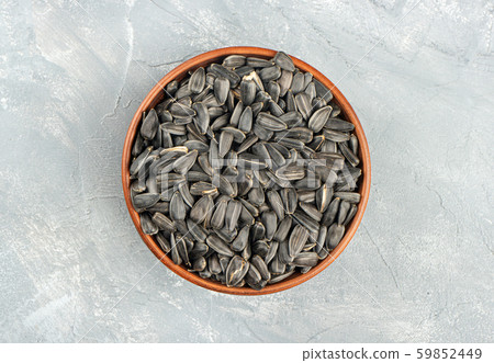 Sunflower seeds in bowl Sunflower seeds in bowl 59852449