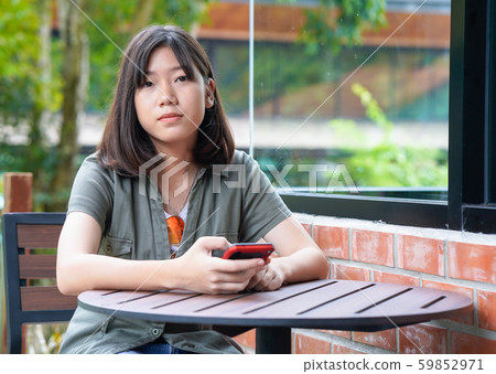 woman sitting in cafe terrace 59852971
