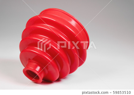 Red automobile axle boots or CV boots on grey gradient background.Spare parts for cars 59853510