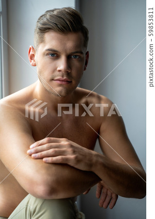 Shirtless man is looking at the camera Shirtless man is looking at the camera 59853811