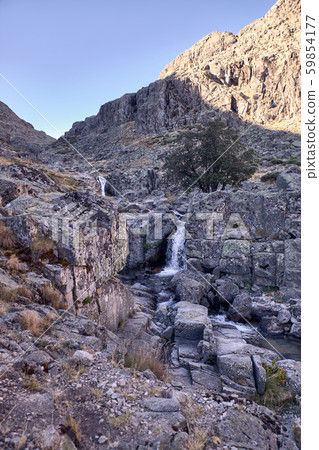 small waterfall of a mountain river small waterfall of a mountain river 59854177