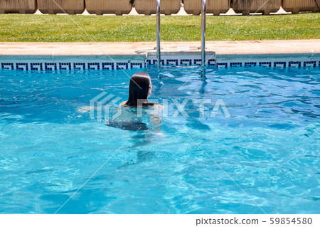 woman swimming in a pool 59854580
