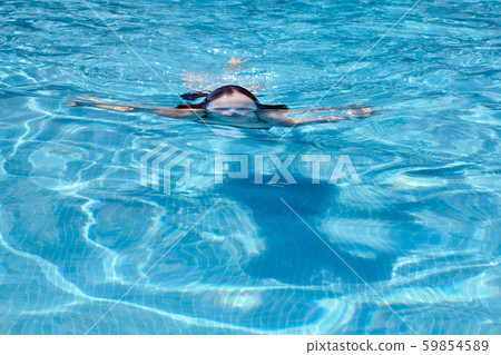 woman swimming in a pool 59854589
