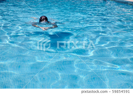 woman swimming in a pool woman swimming in a pool 59854591