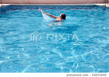 woman swimming in a pool 59854840