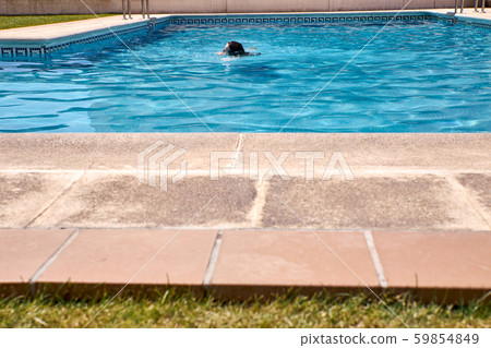 woman swimming in a pool woman swimming in a pool 59854849