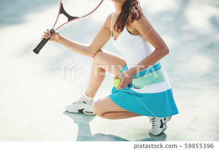 A beautiful woman wearing a sportswear tennis ball. 59855396