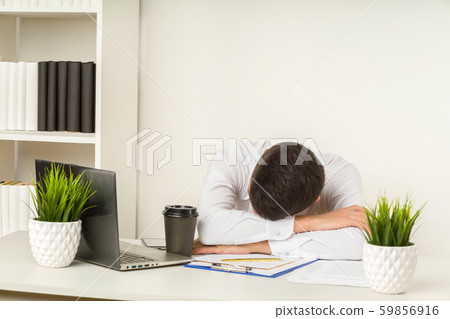 Tired asian businessman sleeping in office. Middle 59856916