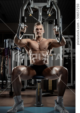guy bodybuilder with apparatus Butterfly Machine 59857250