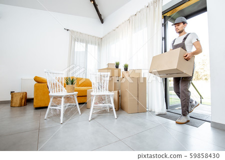 Professional mover delivering furniture to a new house Professional mover delivering furniture to a new house 59858430