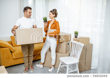 Young couple moving into a new house Young couple moving into a new house 59858444