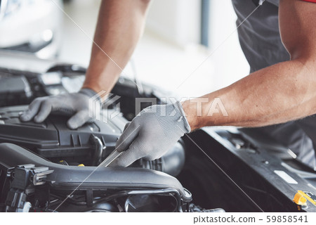 Picture showing muscular car service worker repairing vehicle Picture showing muscular car service worker repairing vehicle 59858541