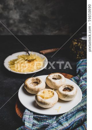 Stuffing mushrooms with grated cheese Stuffing mushrooms with grated cheese 59858690