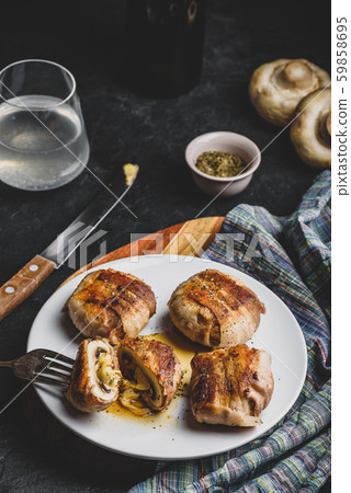 Bacon-wrapped button mushrooms stuffed with cheese 59858695