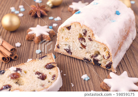 traditional german christmas cake stollen with cookies and decoration on wooden table 59859175