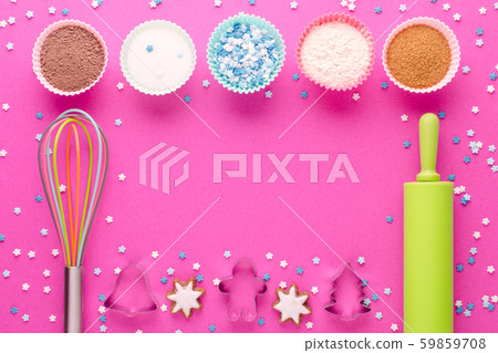 ingredients for baking and kitchen tools with cookie cutter on pink background 59859708