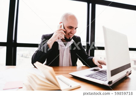Young businessman talking on smartphone at office 59859718