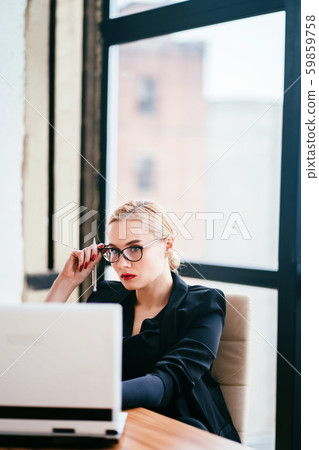 Businesswoman working on laptop at office room Businesswoman working on laptop at office room 59859758