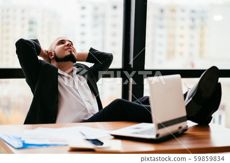 Successful businessman satisfied and relaxed Successful businessman satisfied and relaxed 59859834