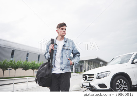 photo of a young man before an exciting trip at the airport. photo of a young man before an exciting trip at the airport. 59860012