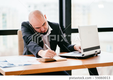 Young businessman multitasking, office routine 59860013