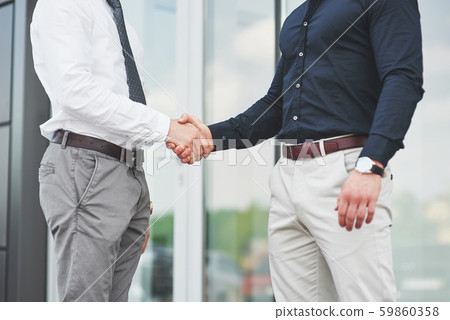 Handshake of two men. Successful business contacts after a good deal 59860358