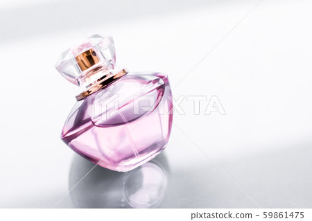 Pink perfume bottle on glossy background, sweet 59861475