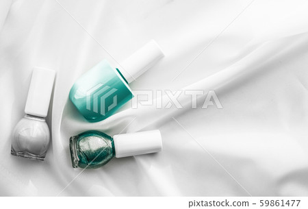 Nail polish bottles on silk background, french 59861477