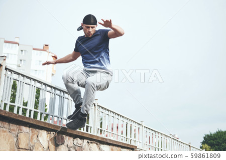Young sports man doing parkour in the city. 59861809