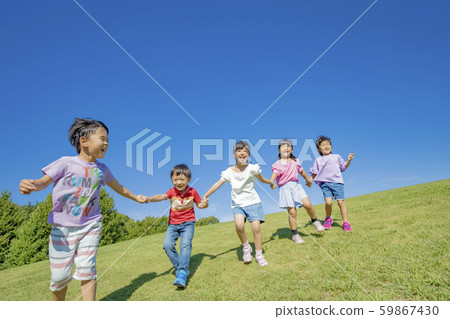 Children playing on the hill in the park Children playing on the hill in the park 59867430