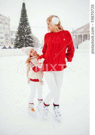 Cute and beautiful family in a winter city 59870726