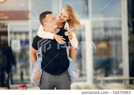 Beautiful couple standing in a airport 59870963