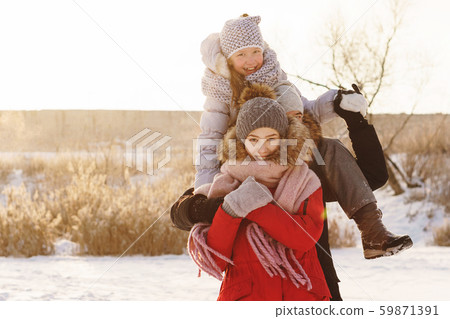 Group of teenage friends having fun snow in winter 59871391