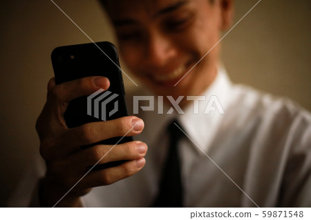Man operating a smartphone Fraud image 59871548