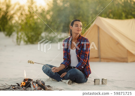 Woman Camping Near Campfire 59871725