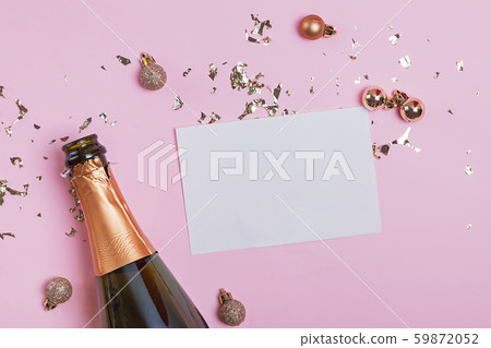 Blank paper card mock-up on the pink background with golden confetti and champagne bottle Blank paper card mock-up on the pink background with golden confetti and champagne bottle 59872052