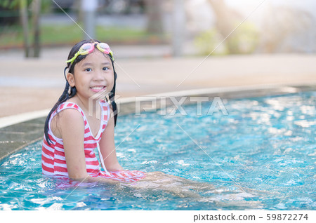 Girl wear goggle and smile in swimming pool, Girl wear goggle and smile in swimming pool, 59872274
