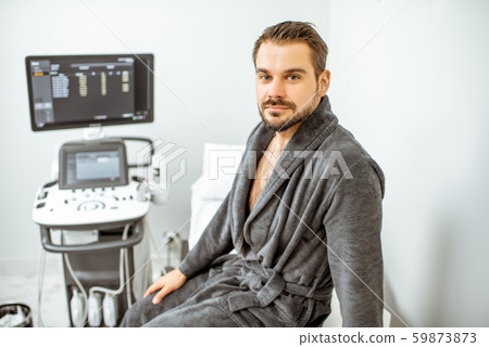 Man at the medical office with ultarsound diagnostics Man at the medical office with ultarsound diagnostics 59873873