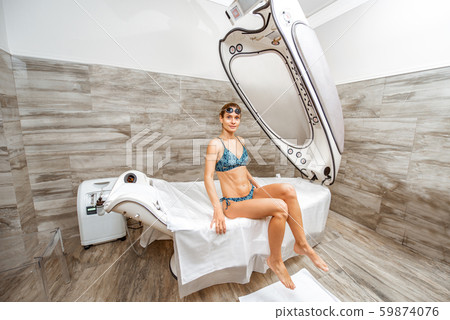 Woman on the spa capsule in the beauty salon Woman on the spa capsule in the beauty salon 59874076