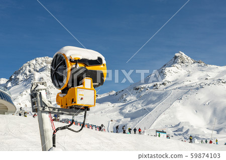 Artificial Snow cannon near piste.Ski lift ropeway on hilghland alpine mountain winter resort on Artificial Snow cannon near piste.Ski lift ropeway on hilghland alpine mountain winter resort on 59874103