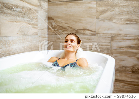 Woman having hydromassage therapy Woman having hydromassage therapy 59874530