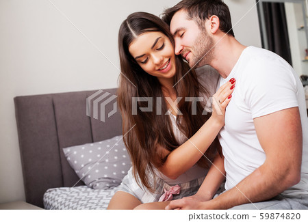 Loving couple relaxing in bed at home Loving couple relaxing in bed at home 59874820