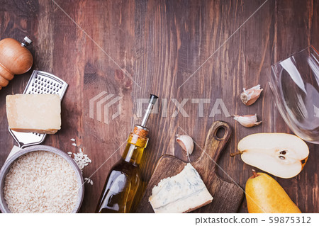 Ingredients for cooking risotto with pear and gorgonzola cheese on wooden table 59875312