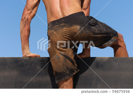 Mud race runners running over obstacles extreme sport Mud race runners running over obstacles extreme sport 59875936